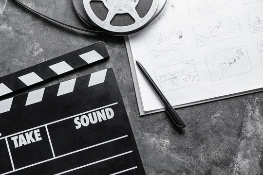 Storyboard with movie clapper and film reel on dark background