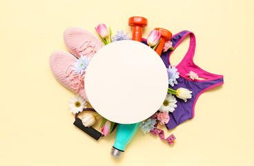 Blank card with sports equipment and spring flowers on yellow background