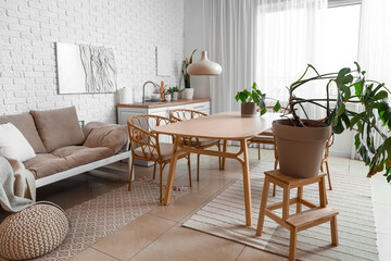 Interior of modern dining room with green houseplants