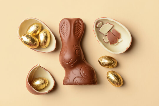Chocolate Easter eggs and bunny on beige background