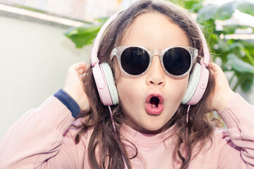 Music in the Sun: Little Girl Listening to Tunes with Sunglasses and Headphones