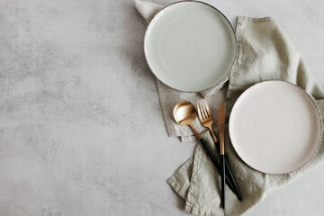 Plates mockup with copy space.Modern minimal table place setting neutral beige color on gray...