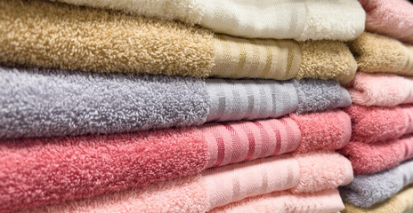 Stack of colorful towels. Fresh new fluffy towels. Pile stacked colored fabric towels. Stack...