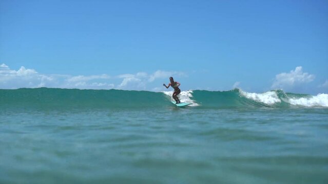 Girl Surfing a Longboard filmed from underwater, Slow motion, Noosa Australia