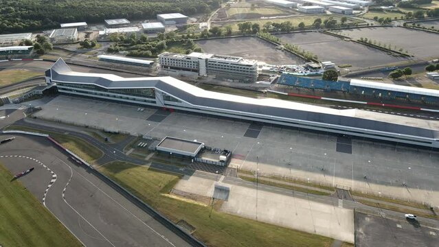 Aerial view circling Silverstone British motorsport international pit straight and race track circuit