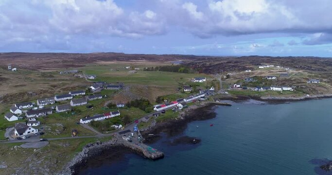 Aerial pan across the village of Aringour on the Island of Coll above the sea inlet