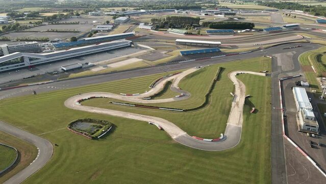Aerial flyover view above Silverstone British motorsport racetrack F1 circuit turns and bends