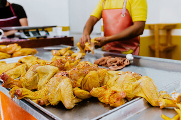 latin man hands of Poultry vendor with raw chickens being sliced by the Pollero at Chicken shop or Polleria in Mexican market in Mexico Latin America