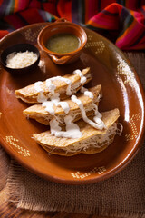 Potato quesadillas. Fried quesadillas made with corn tortillas, they can be filled with any dish or ingredient, such as meat, potato or fish such as marlin or tuna, popular during the Lenten season.