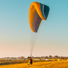 Yellow and blue glider at sunset