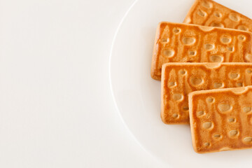 Cookies rectangular sweet flat, on white wooden board background, top view, space to copy text, selective focus