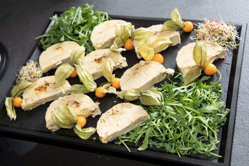 foie gras french food in black slate with tomatoes and salad fresh