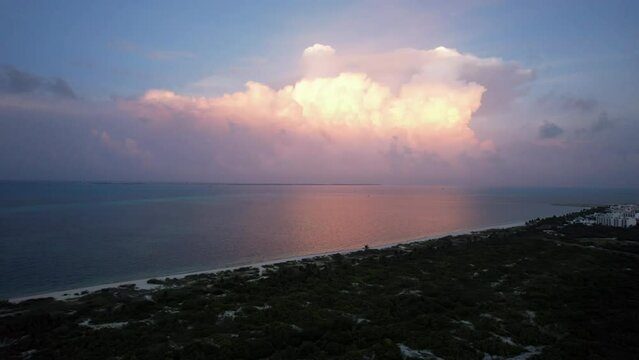 Sunset fly over the waters of the Gulf of Mexico. Located in Cancun, Mexico. Aerial 4K drone video