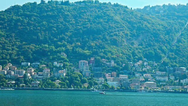 San Bartolomeo view with beautiful colourful houses from Como coast in Italy. Beautiful famous villas and mansions by the coast of Lake Como in the sunny summer.