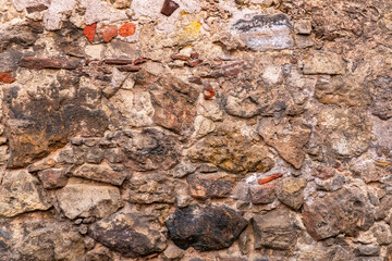 The surface of the ancient masonry of natural stones.