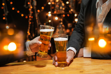 food and drink male friends are happy drinking beer and clinking glasses at a bar or pub.