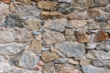The surface of the ancient masonry of natural stones.