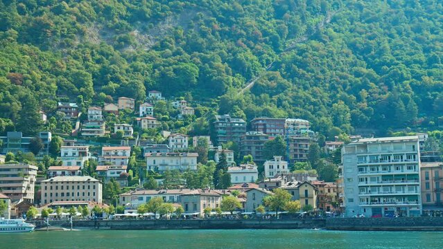 San Bartolomeo view with beautiful colourful houses from Como coast in Italy. Beautiful famous villas and mansions by the coast of Lake Como in the sunny summer.