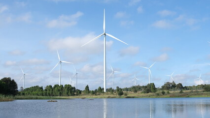 Aerial view of powerful Wind turbine generator for renewable energy production on beautiful sky at...