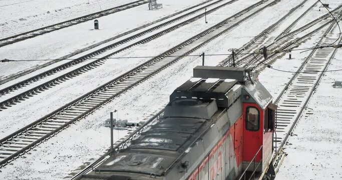 Cargo transportation. A diesel freight train with bags of lime in open wagons passes along the railway track. Hand held.
