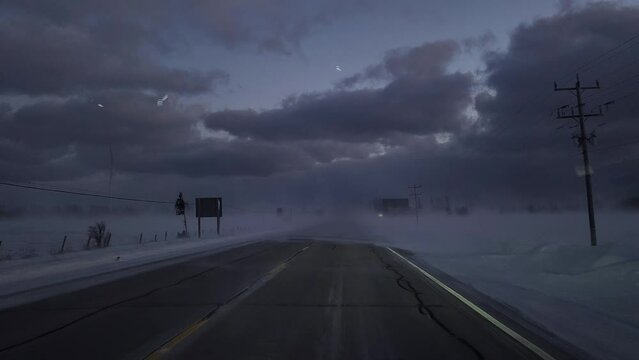 Driving Winter Snow Storm on Rural Road in the Evening at Sunset. Driver Point of View POV Snowing Blizzard Snowfall on Countryside Road in Owen Sound, Ontario, Canada