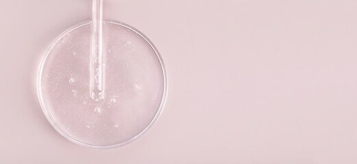 glass pipette serum gel closeup in petri dish on beige background