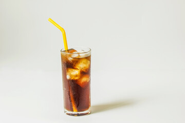 Fresh coke in glass with straw isolated on white background