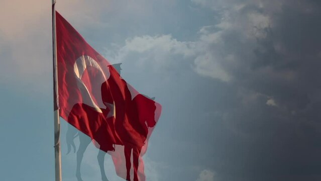 Turkish Flag and silhouette of the monument of Ataturk. National holidays of Turkiye concept video. 19 mayis or 19th may 4K footage with copy space for text.