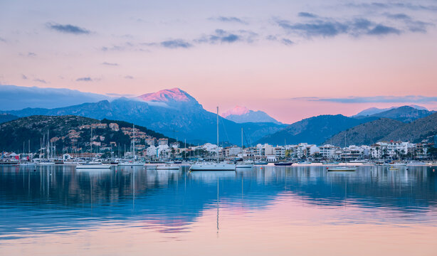 Sunrise and alpine glow on the mountains of the Tramuntana from port de Pollenca Majorca Spain