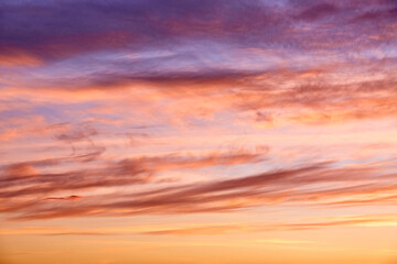 Purple, pink and orange tints clouds in the blue sky at sunset. Layered clouds. Scenic wallpaper. Nature background. Colorful space. Evening cloudscape. Peace concept. Heaven paradise. Pure