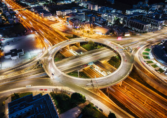 Fototapeta na wymiar A illuminated multilevel highway junction interchange during night time with blurred car traffic as seen in Athens, Greece