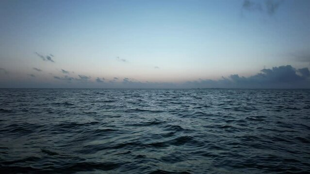 Sunrise fly over the waters of the Gulf of Mexico. Located in Cancun, Mexico. Aerial 4K drone video