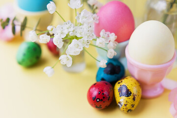 Easter eggs, flowers on yellow background