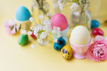 Easter eggs, flowers on yellow background