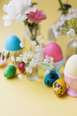 Easter eggs, flowers on yellow background