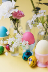 Easter eggs, flowers on yellow background