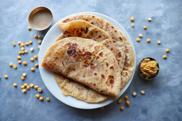 Puran Poli is an Indian sweet flatbread stuffed with chana dal, jaggery, ghee and cardamom and is...
