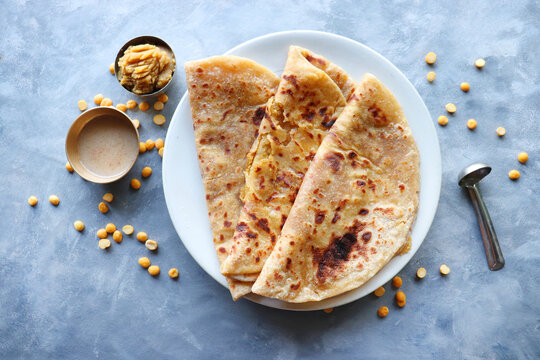 Puran Poli is an Indian sweet flatbread stuffed with chana dal, jaggery, ghee and cardamom and is usually eaten at Holi or Gudi Padva festival. Recipe ingredients. copy space. Healthy sweet dessert.