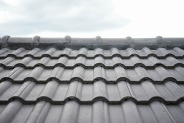 concept for house roof icon with gray tiled banner texture for roof gray tile background