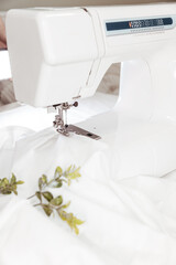 The sewing machine sews the product. For seamstresses, making clothes, accessories, handicrafts, close up