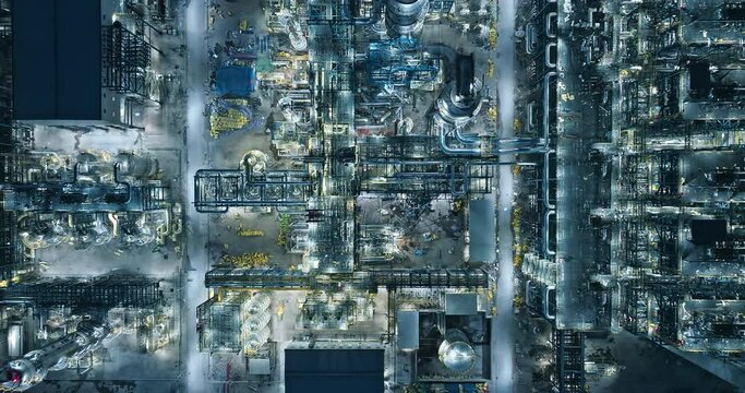 Aerial view of oil and gas petrochemical industrial with Refinery factory. industrial area buildings scenery at night. High Angle view.