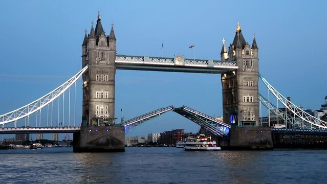London Tower Drawbridge opening to allow a ship to sail through the Thames at night