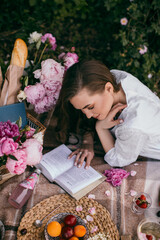 Picnic on nature. Young woman having picnic with champagne 