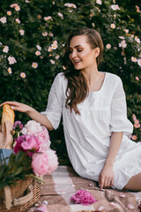 Picnic on nature. Young woman having picnic with champagne 