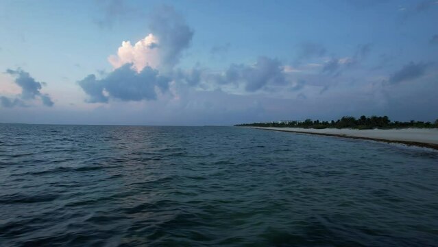 Sunrise fly over the waters of the Gulf of Mexico. Located in Cancun, Mexico. Aerial 4K drone video