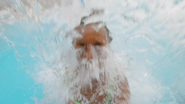 Medium Close-up Portrait Of African American Woman Having Fun In Hot Springs Pool Jumping And Going Underwater