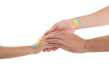 Man and woman with painted Ukrainian flags on their hands against white background, closeup