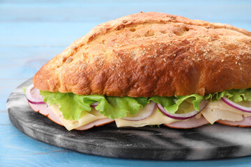 Delicious sandwich with fresh vegetables and cheese on gray marble board, closeup