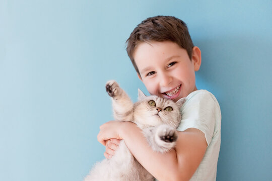 Child and cat on blue background