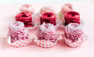 Close up view of delicious pink cupcakes on table, top view